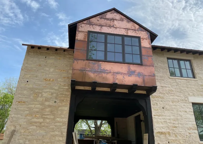 Copper metal panel facade on a stone building for Skylight Installation in Bossier City